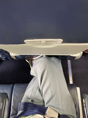 Passenger sleeping on the seat in the airplane. Travel concept.の写真素材