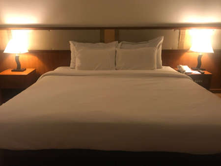 Double bed with white pillow in the hotel bedroom. Interior design.の写真素材