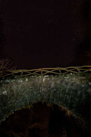 Old stone bridge and starry skyの写真素材