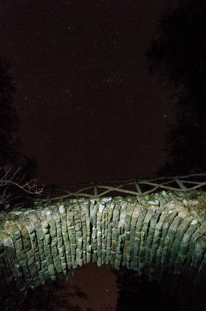 Old stone bridge and starry sky