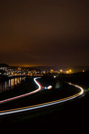 Street train and river at nightの写真素材