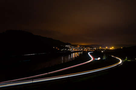 Street train and river at nightの写真素材