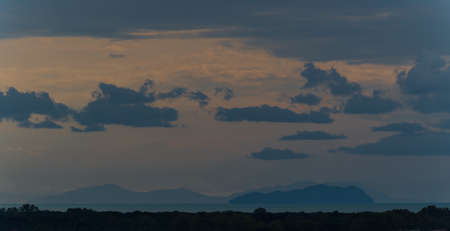 far out sunset island with cloudsの写真素材