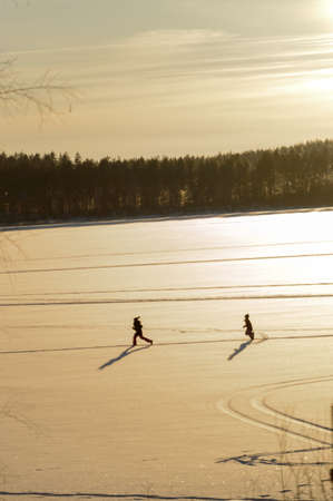 Children in Scandinavia winter sunsetの写真素材
