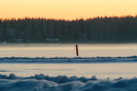 Scandinavia winter sunset frozen lakeの写真素材