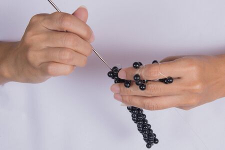 Women make their own bracelets.