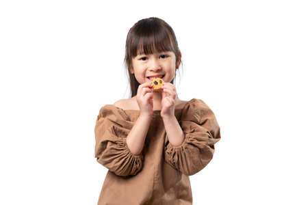 Portrait of happy girl eating whole grains cookie isolated on white background