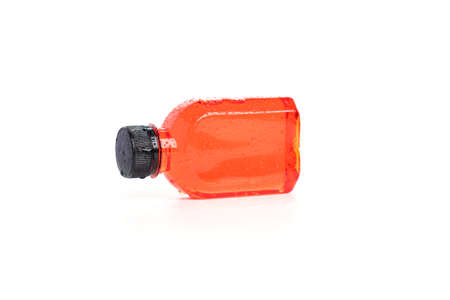 Fresh pomegranate juice packed in a small plastic bottle on white background. Tea in plastic bottle,...