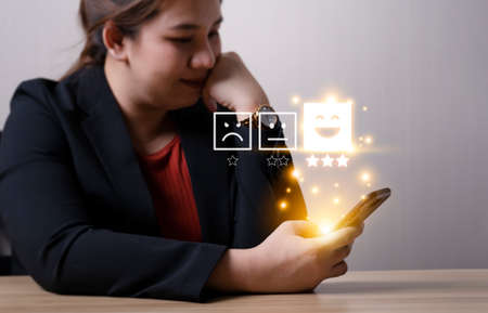 Rating of business women with highest satisfaction icon. Customer Satisfaction Survey Concept service rating Business Satisfaction Survey review comments Press the smiley face emoticon.の写真素材