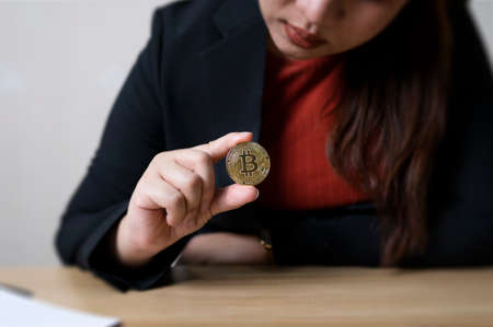Business woman in hand bitcoin coins with crypto trading chart. cryptocurrency exchange. technology and investment digital concept. finance, Trader, investor, gold Bitcoin Cashの写真素材