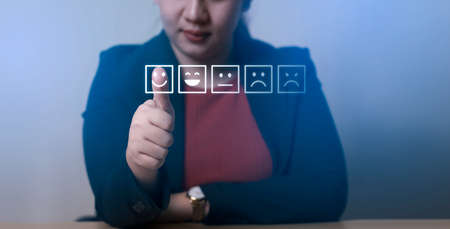 Rating of business women with highest satisfaction icon. Customer Satisfaction Survey Concept service rating Business Satisfaction Survey review comments Press the smiley face emoticon.の写真素材
