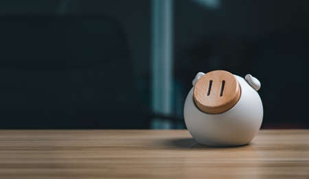Pig piggy bank on wooden table, future money saving and pensions conceptの写真素材