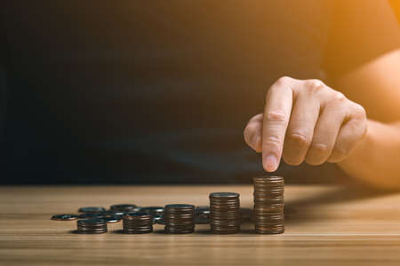 businessman stacking coins. save money and investment growth concept. Savings and pensions,...