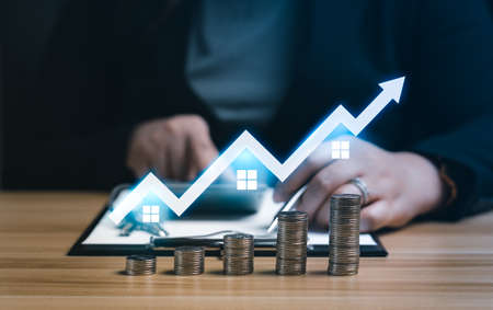Real Estate Market Growth Concept.businesswoman or a home or real estate broker is calculating...