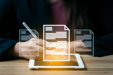 business woman uses a pen to sign electronic documents on digital documents on a virtual screen....