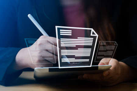business woman uses a pen to sign electronic documents on digital documents on a virtual screen. electronic signature, Technology and document managementの写真素材