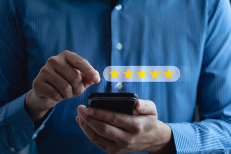 Measuring how happy customers are with a business's products or services through smartphone screen application to choose 5 star. reviews, opinions, recommendations, Customer Expectationsの写真素材