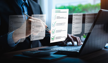 Business performance checklist, businessman using laptop doing online checklist survey, Check marks on checklist and Filling online form or answering questions. evaluation, online survey, online examの写真素材
