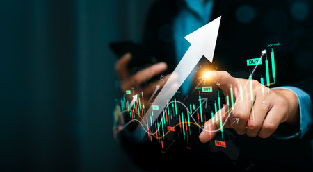 Businessman Using Smartphone to Analyze Stock Market Trends with Digital Financial Chart, Upward Arrow, Candlestick Graphs Indicating Investment Growth, Trading Strategies, and Financial Opportunitiesの写真素材