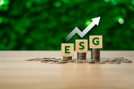 ESG investment strategy concept with wooden blocks labeled Environment, Social, and Governance on stacked coins, showing financial growth, sustainable business, and responsible investment return trendの写真素材