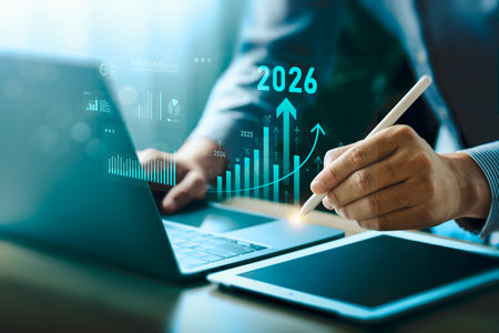 Businessman analyzing digital financial growth charts with upward trends and 2026 target, using...