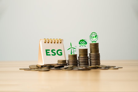 ESG investment concept with stacked coins and environmental icons representing renewable energy, carbon footprint reduction, and sustainable responsibility for long-term financial growth strategyの写真素材