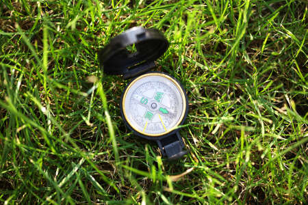 Army compass placed on the grass viewed from aboveの写真素材
