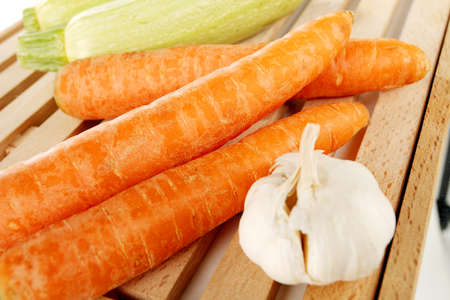 Vegetables on a wooden plate on a white backgroundの写真素材