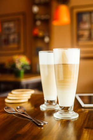 2 latte on a wooden tableの写真素材
