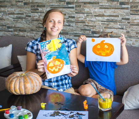 Mom with son draw  pumpkin for Halloweenの写真素材