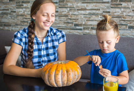 Mom with son draw  pumpkin for Halloweenの写真素材