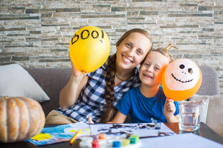 Woman and her son are hiding behind the ball.の写真素材