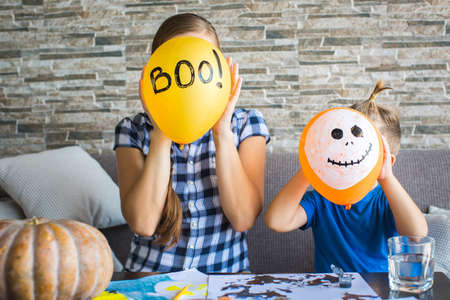 Woman and her son are hiding behind the ballの写真素材