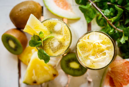 Smoothies of kiwi and pineapple on the table. Top viewの写真素材