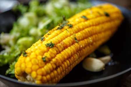 Baked corn with salad