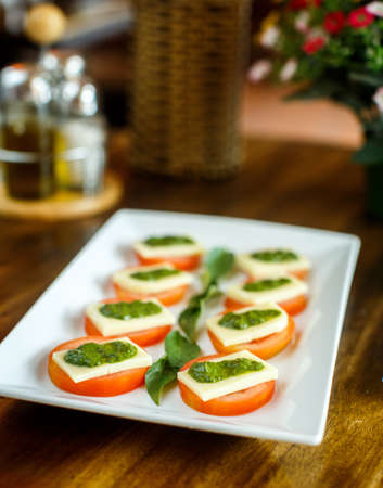 Caprese salad on a wooden tableの写真素材