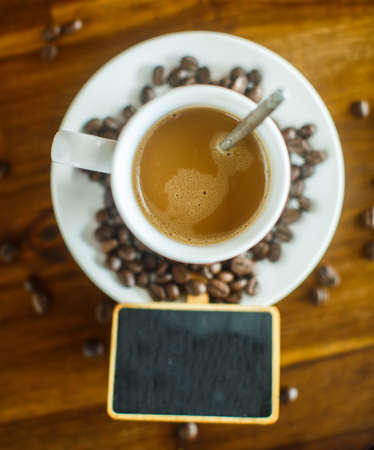 cup of coffee and antique blackboard with space for text