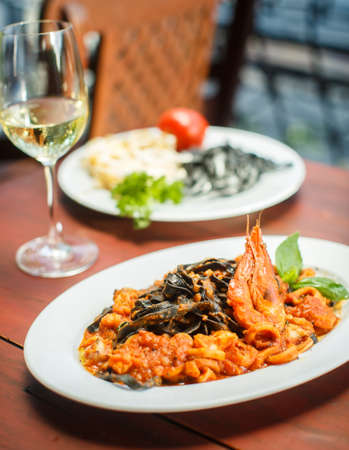Traditional Italian dish - black tagliatelle with seafoodの写真素材