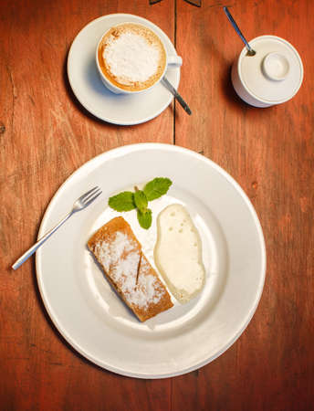 Apple strudel with sauce and coffeeの写真素材