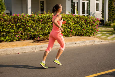 Running woman in sporty running clothes.
