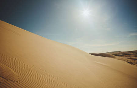 Sand dunes at sunset casting nice shadows in Muine, Vietnam