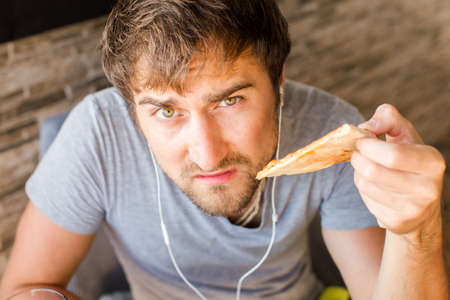 Man working at the computer and eating fast food. Unhealthy Lifestyle.