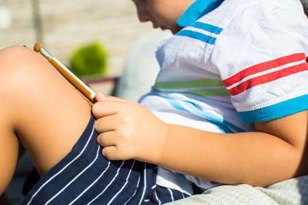 Boy playing with digital tabletの写真素材