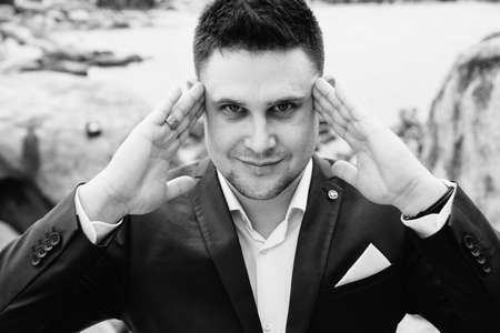 Portrait young business man in suit against the sea, Film toneの写真素材