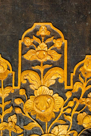 Pattern of flowers carved on woodの写真素材