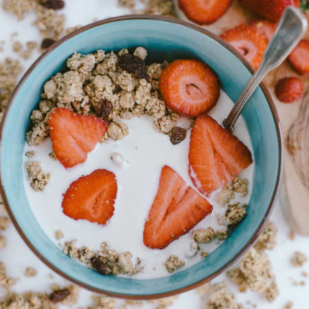 Fresh strawberries , yogurt and homemade granola for healthy breakfastの写真素材
