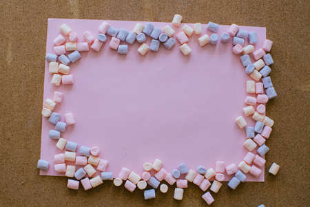 Sweet Pink Background with Multicolored Marshmallows