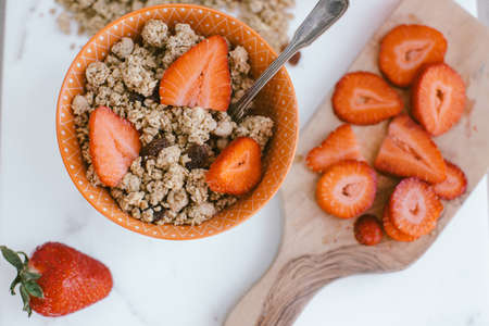 Fresh strawberries , yogurt and homemade granola for healthy breakfastの写真素材