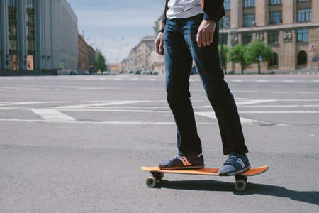 Fashion man on a skateboard in the cityの写真素材