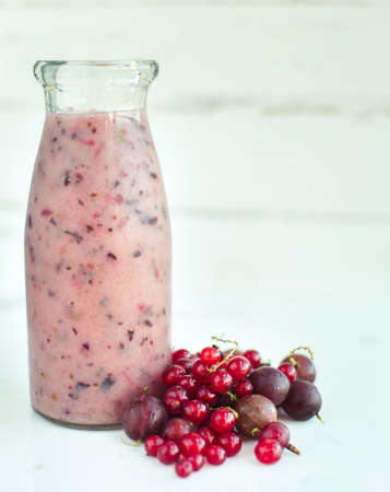 Red smoothie with frozen berries,currants and gooseberries, selective focusの写真素材